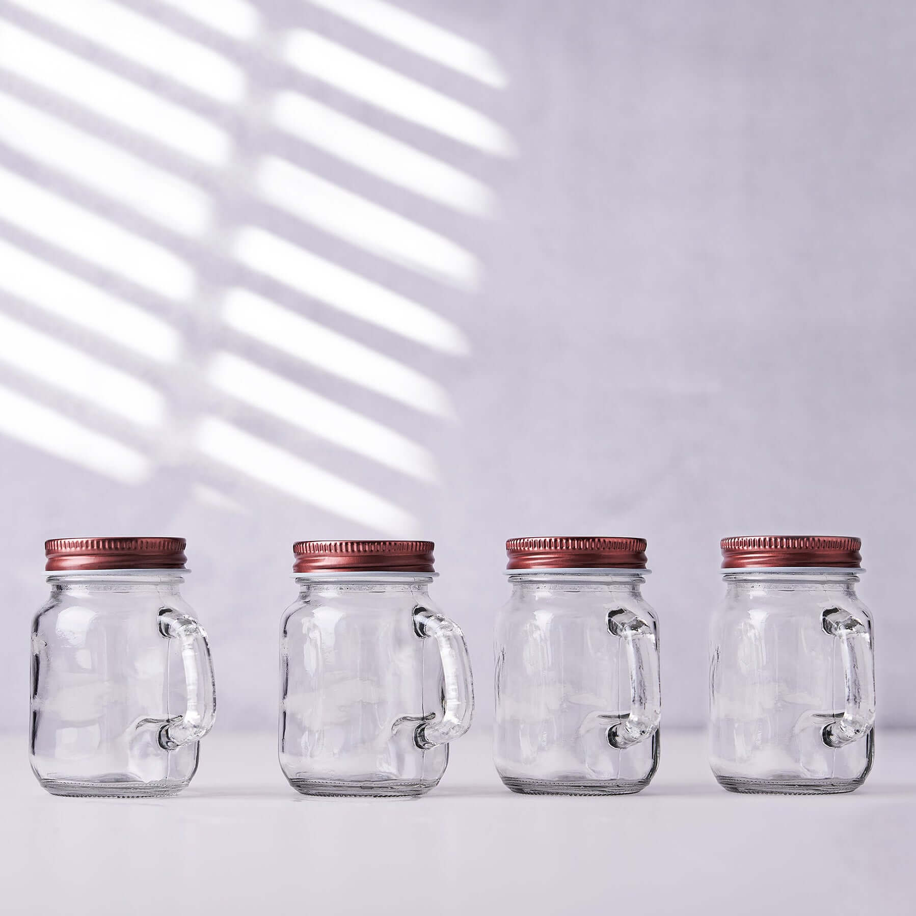 4-Pack Clear Glass Mason Jars 4oz Rustic Design with Handles and Rose Gold Screw-On Lids - Stylish Storage for Beverages & Decor